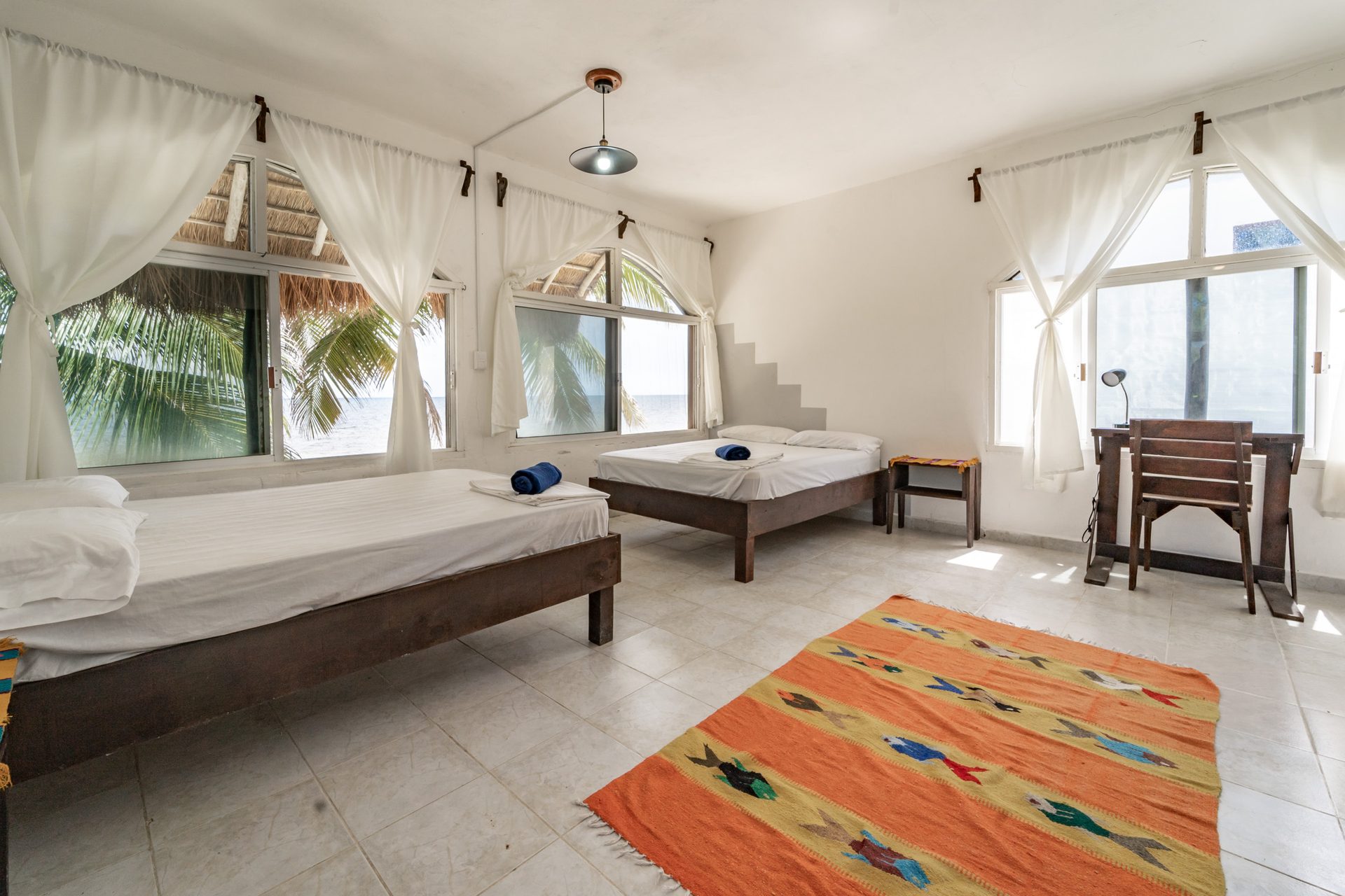Room Moon interior — two double beds facing the beach